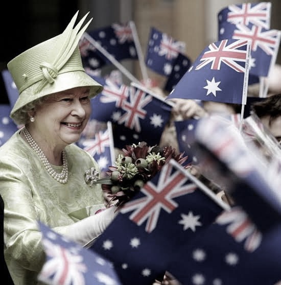 Queen Elizabeth II surrounded by waving flags