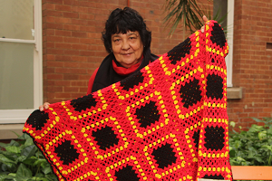 Photograph of staff member holding blanket