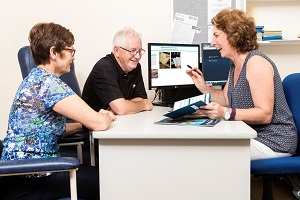 Photo of staff member discussing a resource with a patient