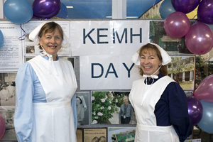 Two women dressed in old fashioned nurses uniforms