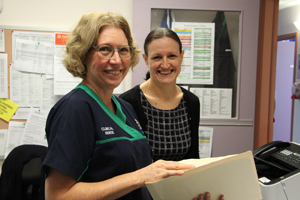 Two nurses reviewing a file