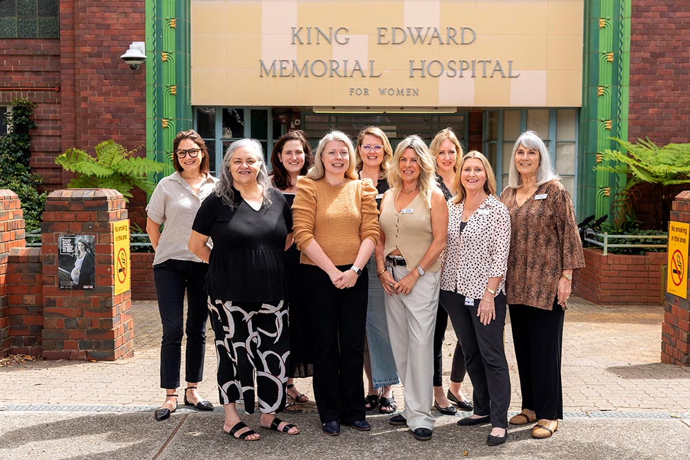 A group of laddies standing outside the entrance of King Edward Memorial Hospital